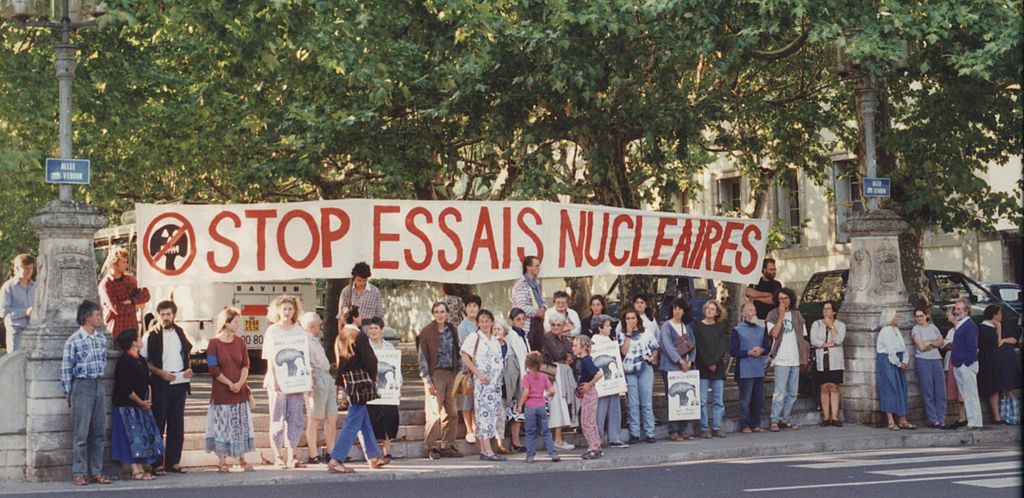 Anti nuclear test protesters holding banner
