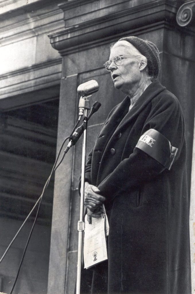 Dorothy Day speaking into a microphone